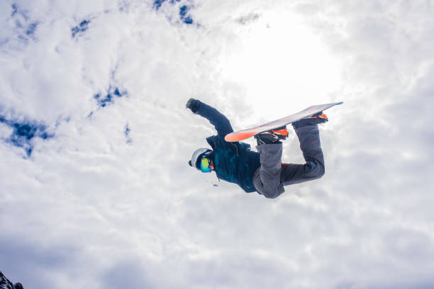 istock Male snowboarder in mid air 829762384