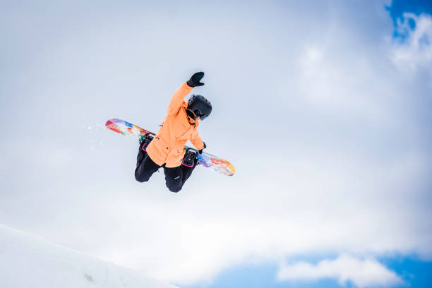 istock Female snowboarder in mid air 829762416