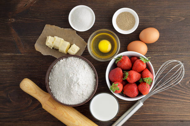 istock Baking background with ingredients for strawberry pie on rustic wooden table. 829770460