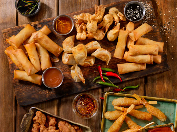 Asian Appetizers Asian Appetizers, Dumplings, Spring Rolls, Shrimp, Wontons, Dry Ribs and Sauces chinese dumpling photos stock pictures, royalty-free photos & images