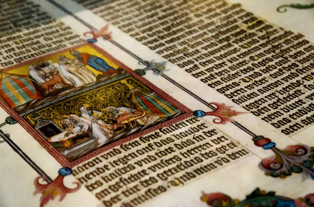 Vienna, old tome in Austrian National Library Vienna, Austria - May 20, 2017: An ancient tome with miniature illustration, open inside a display case of the Austrian National Library, famous historic library of Vienna, on may 20, 2017 medieval stock pictures, royalty-free photos & images