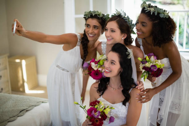 istock Bride and bridesmaid taking selfie at home 829775736