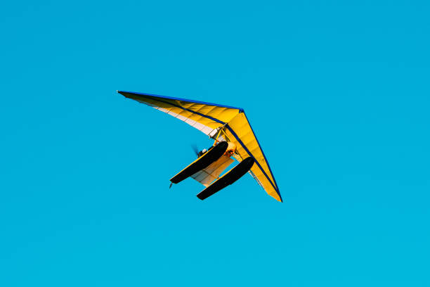 istock Motorized Hang Glider Flying On Blue Clear Sunny Sky Background 829775804