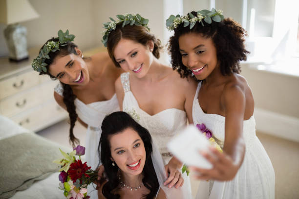 istock Bride and bridesmaid taking selfie at home 829775838