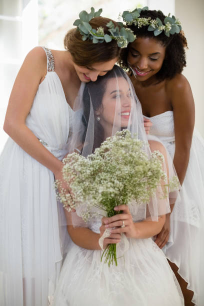 istock Bride interacting with bridesmaid at home 829778248