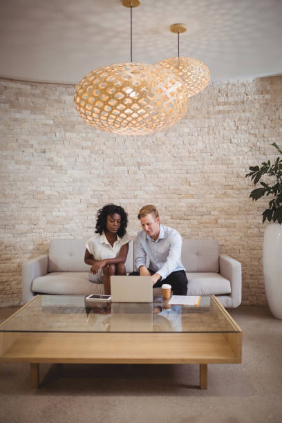 istock Attentive executives discussing over laptop 829778734
