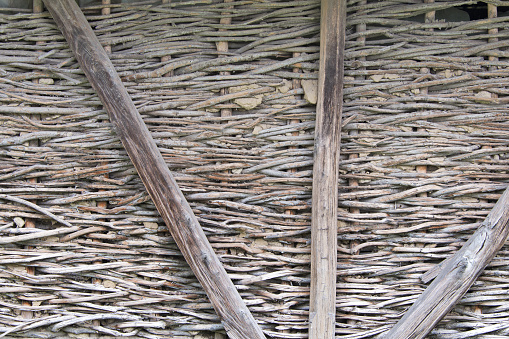 An old wall of interwoven branches and mud.