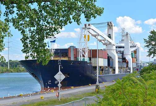 A large freighter loaded with cargo, makes its way through a lock in the St Lawrence Seaway system.