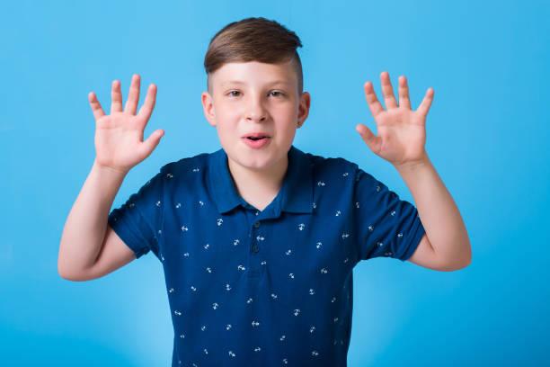 istock emotional boy waving his hands and poin at something 829782406