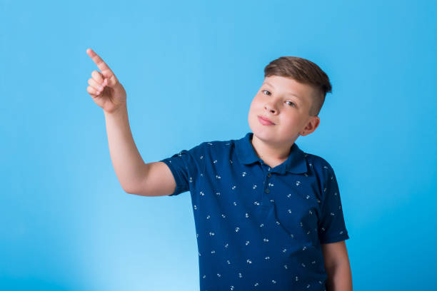 istock emotional boy waving his hands and poin at something 829782496