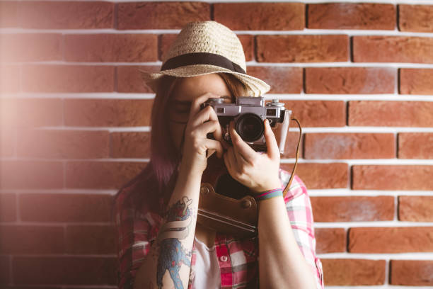 istock Woman photographing from vintage camera 829805462