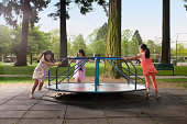 kids on carousal in playground