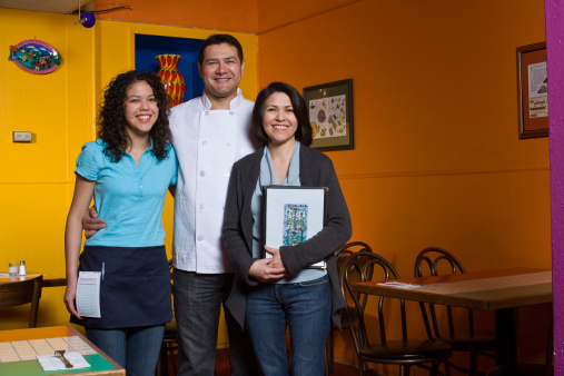 family portrait of small business owners. mexican restaurant owners