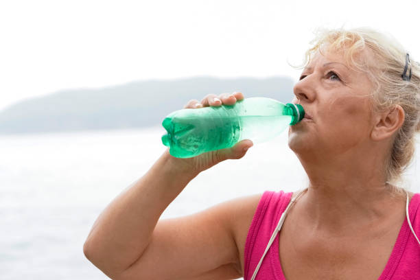 istock Mature  woman exercise outdoors by the sea 829825898