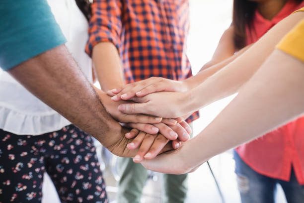 istock Close up of business colleagues stacking hands 829831906