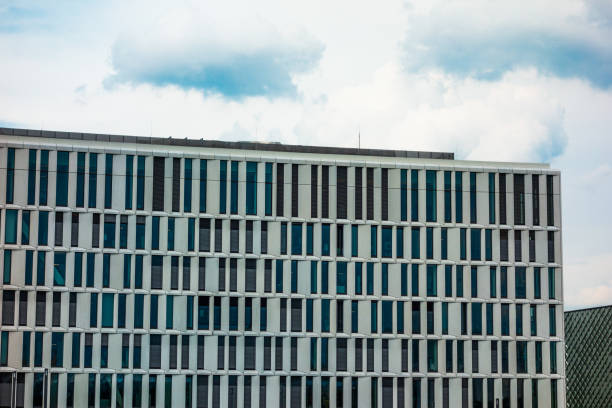 istock modern office building with small windows on a cloudy day 829839222