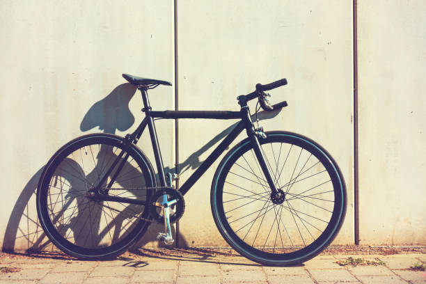 istock Mans bicycle leaning against a wall in sunshine 829848972