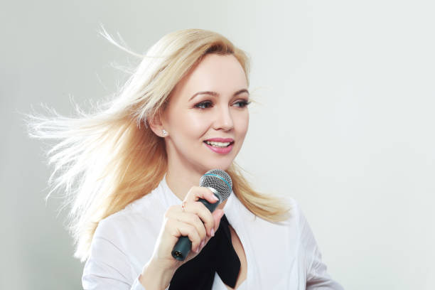 istock woman holding microphone 829850784
