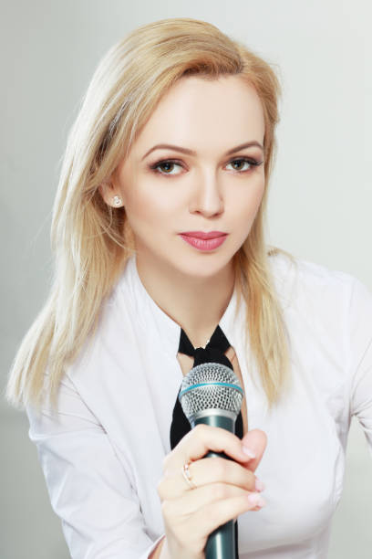 istock woman holding microphone 829868360