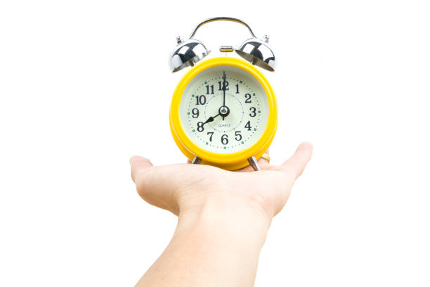 istock alarm clock in a hand isolated on white 829910494