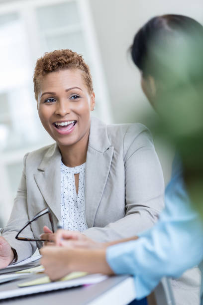 istock Cheerful businesswoman talks with client 829917224