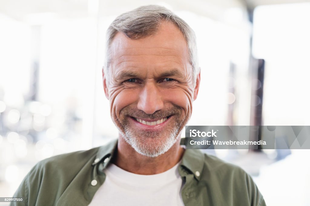 Smiling businessman in office Portrait of smiling businessman in office 50-54 Years Stock Photo