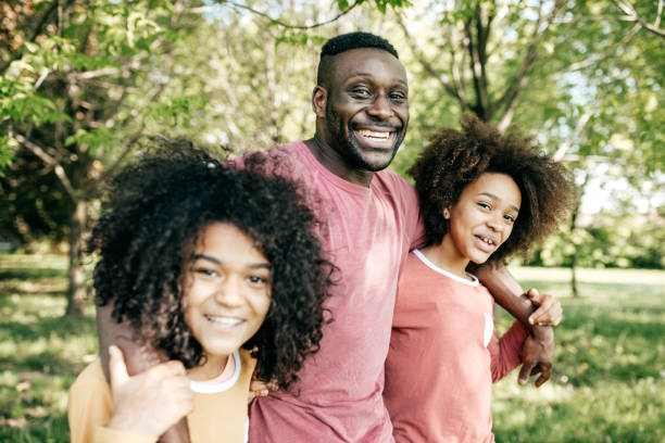 istock Dad and daughters having fun on the park 829922264