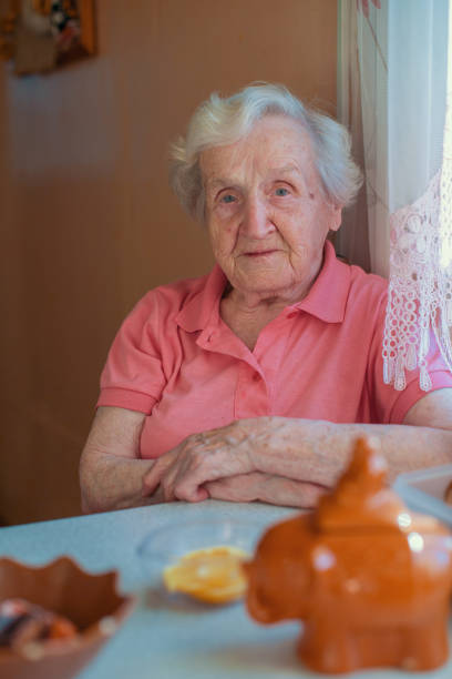 istock An elderly woman in her home, portrait at kitchen. 829937142