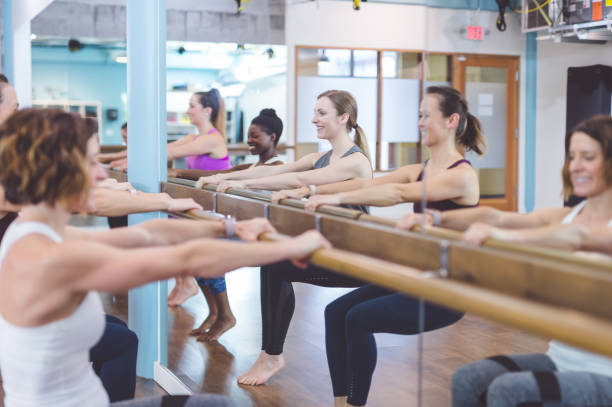 istock Multi-ethnic group of women doing barre workout 829938262