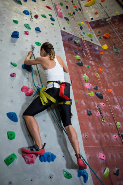 istock Woman practicing rock climbing in fitness studio 829942292