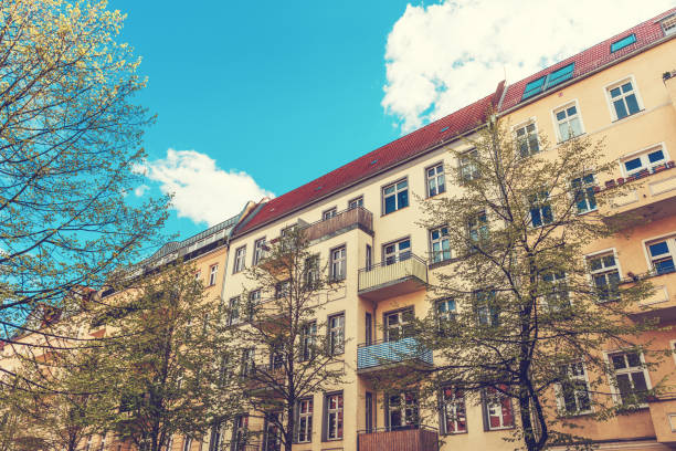 istock yellow living houses with trees in the front 829943938
