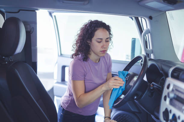 istock Woman cleaning inside of car 829966462