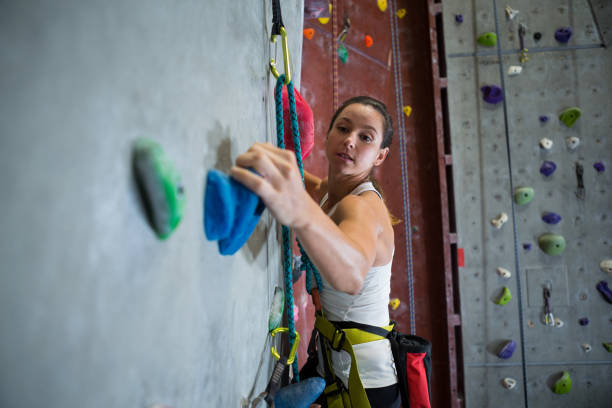 istock Woman practicing rock climbing in fitness studio 829968242