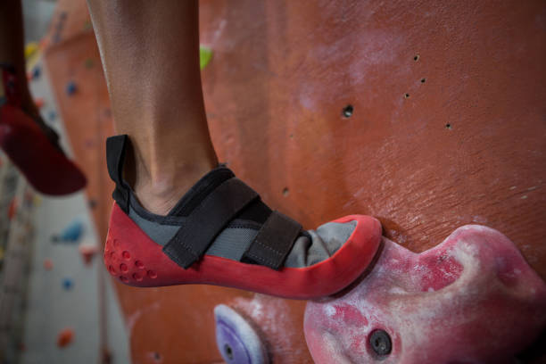 istock Woman practicing rock climbing in fitness studio 829973754