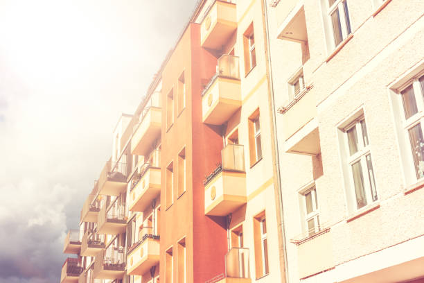 istock warm colored row houses at Berlin on a cloudy day 829986728
