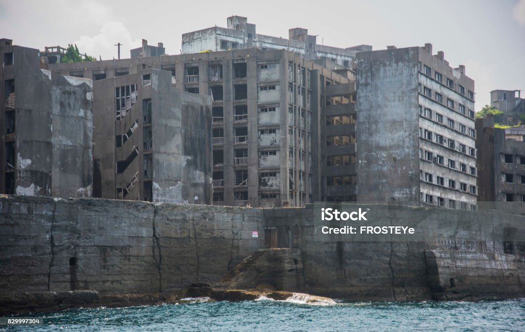 Battleship Island (Gunkanjima, Hashima, Gunkanjima, Gunkanjima, Gunkanjima) Hashima Island (端島 or simply Hashima — -shima is a Japanese suffix for island), commonly called Gunkanjima (軍艦島; meaning Battleship Island), is an abandoned island lying about 15 kilometers (9 miles) from the city of Nagasaki, in southern Japan. It is one of 505 uninhabited islands in Nagasaki Prefecture. The island's most notable features are its abandoned concrete buildings, undisturbed except by nature, and the surrounding sea wall. While the island is a symbol of the rapid industrialization of Japan, it is also a reminder of its dark history as a site of forced labor prior to and during the Second World War. Hashima Island Stock Photo