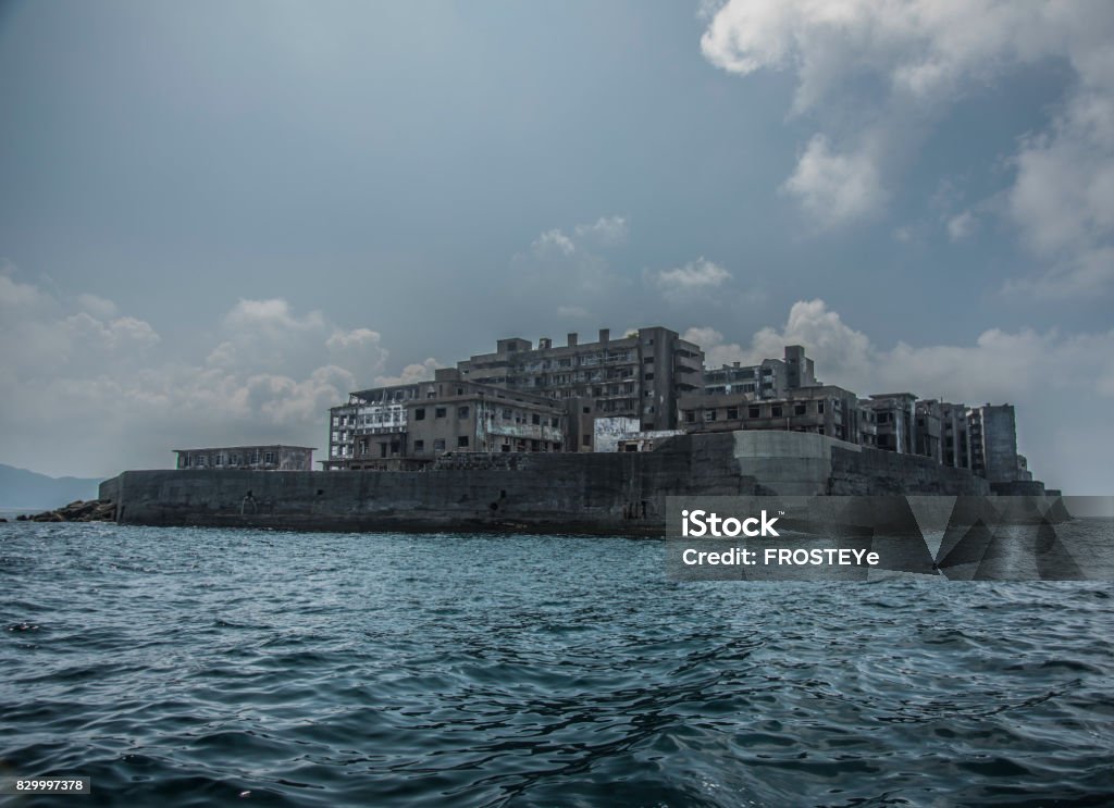 Battleship Island (Gunkanjima, Hashima, Gunkanjima, Gunkanjima, Gunkanjima) Hashima Island (端島 or simply Hashima — -shima is a Japanese suffix for island), commonly called Gunkanjima (軍艦島; meaning Battleship Island), is an abandoned island lying about 15 kilometers (9 miles) from the city of Nagasaki, in southern Japan. It is one of 505 uninhabited islands in Nagasaki Prefecture. The island's most notable features are its abandoned concrete buildings, undisturbed except by nature, and the surrounding sea wall. While the island is a symbol of the rapid industrialization of Japan, it is also a reminder of its dark history as a site of forced labor prior to and during the Second World War. Hashima Island Stock Photo