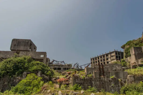 Hashima Island (端島 or simply Hashima — -shima is a Japanese suffix for island), commonly called Gunkanjima (軍艦島; meaning Battleship Island), is an abandoned island lying about 15 kilometers (9 miles) from the city of Nagasaki, in southern Japan. It is one of 505 uninhabited islands in Nagasaki Prefecture. The island's most notable features are its abandoned concrete buildings, undisturbed except by nature, and the surrounding sea wall. While the island is a symbol of the rapid industrialization of Japan, it is also a reminder of its dark history as a site of forced labor prior to and during the Second World War.
