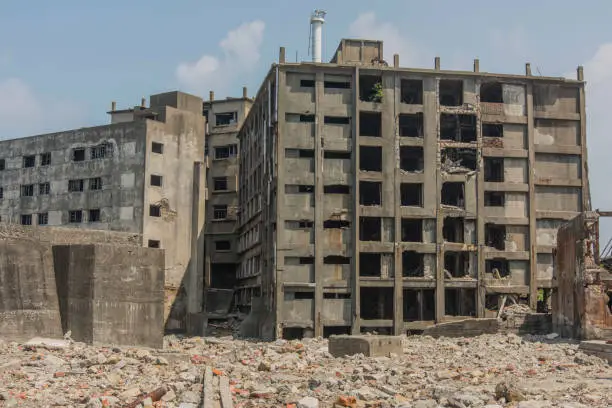 Hashima Island (端島 or simply Hashima — -shima is a Japanese suffix for island), commonly called Gunkanjima (軍艦島; meaning Battleship Island), is an abandoned island lying about 15 kilometers (9 miles) from the city of Nagasaki, in southern Japan. It is one of 505 uninhabited islands in Nagasaki Prefecture. The island's most notable features are its abandoned concrete buildings, undisturbed except by nature, and the surrounding sea wall. While the island is a symbol of the rapid industrialization of Japan, it is also a reminder of its dark history as a site of forced labor prior to and during the Second World War.