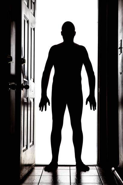 istock Naked man at door in silhouette 830007862