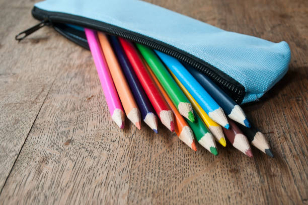 colouring pencils in pencil case on wooden background