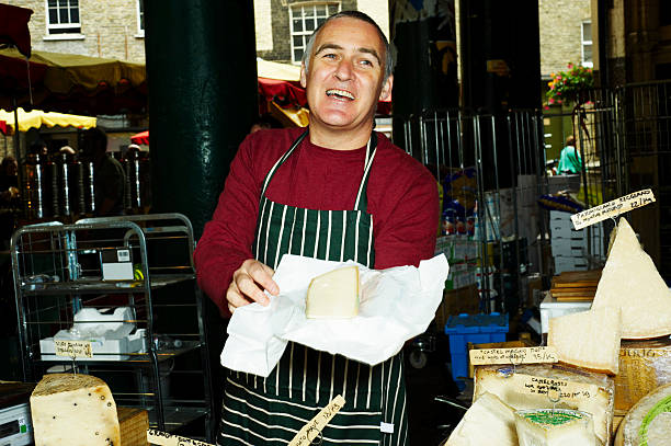 portrait of man selling fresh cheese - retail london england uk people imagens e fotografias de stock