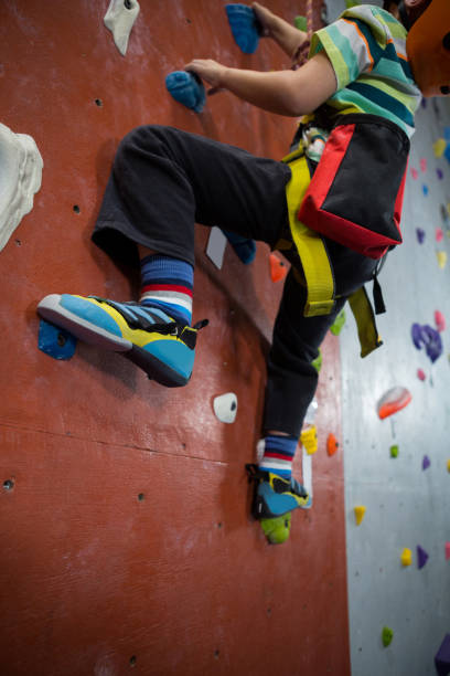 istock Boy practicing rock climbing in fitness studio 830031624