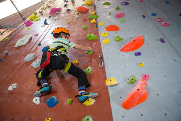 istock Boy practicing rock climbing in fitness studio 830031902