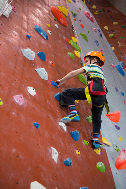 istock Boy practicing rock climbing in fitness studio 830051782