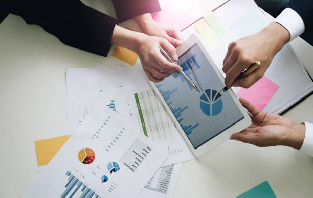 istock Business team hands at working with financial plan, meeting, discussion, brainstrom with tablet on office desk, Top view shot. 830052968