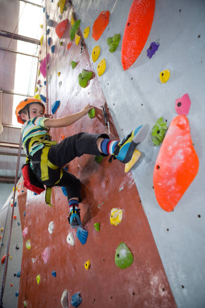 istock Boy practicing rock climbing in fitness studio 830052978