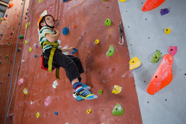 istock Boy practicing rock climbing in fitness studio 830053110