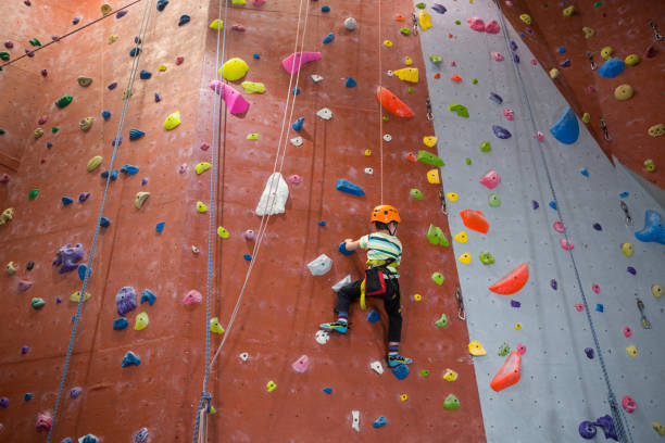 istock Boy practicing rock climbing in fitness studio 830053510