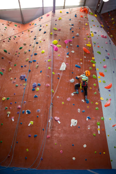 istock Boy practicing rock climbing in fitness studio 830055750